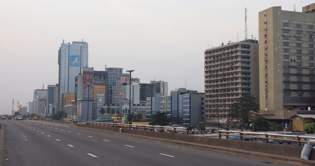 Buildings and a broad road in Lagos, Nigeria, photographed in 2015.